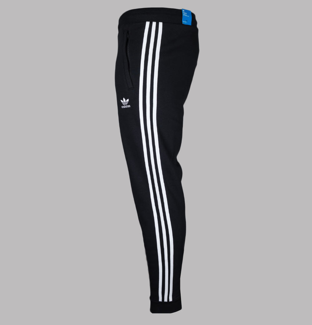 Black Adidas Adicolor Classics 3-Stripes joggers with white stripes on the legs and embroidered trefoil logo.